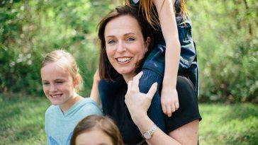 Une femme et ses deux filles posent pour une photo de famille.