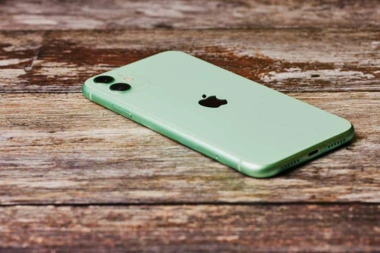 iPhone vert, table en bois.