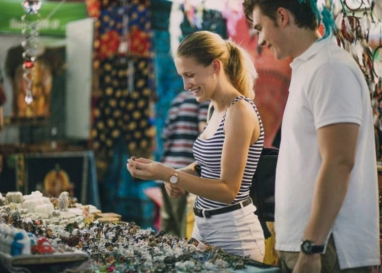 Un couple parcourant des bijoux sur un marché de produits à succès.