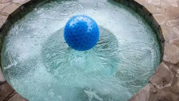 Une boule bleue flottante ajoute de l'ambiance à la soirée spa sous les étoiles.