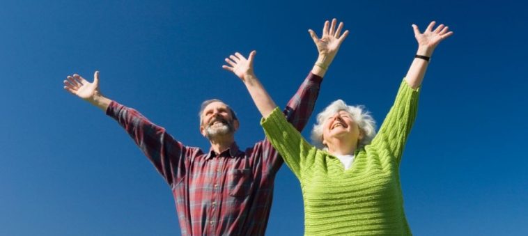 Un couple âgé exprimant sa joie et son bonheur tout en embrassant le concept de bien-être et de confort personnel.